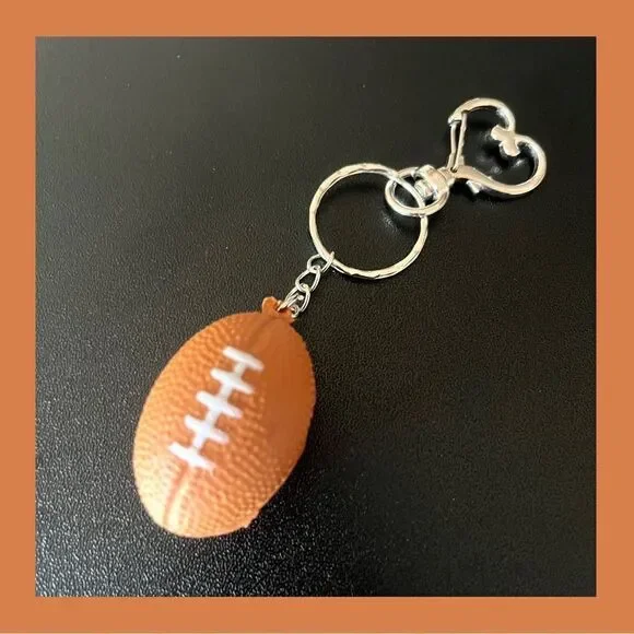 NWOT. Football Keychain includes Heart Shape Silver Medal Spring Snap Clip. - Picture 1 of 7